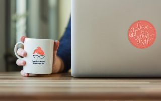 heather marie creative branding on mug and sticker on laptop