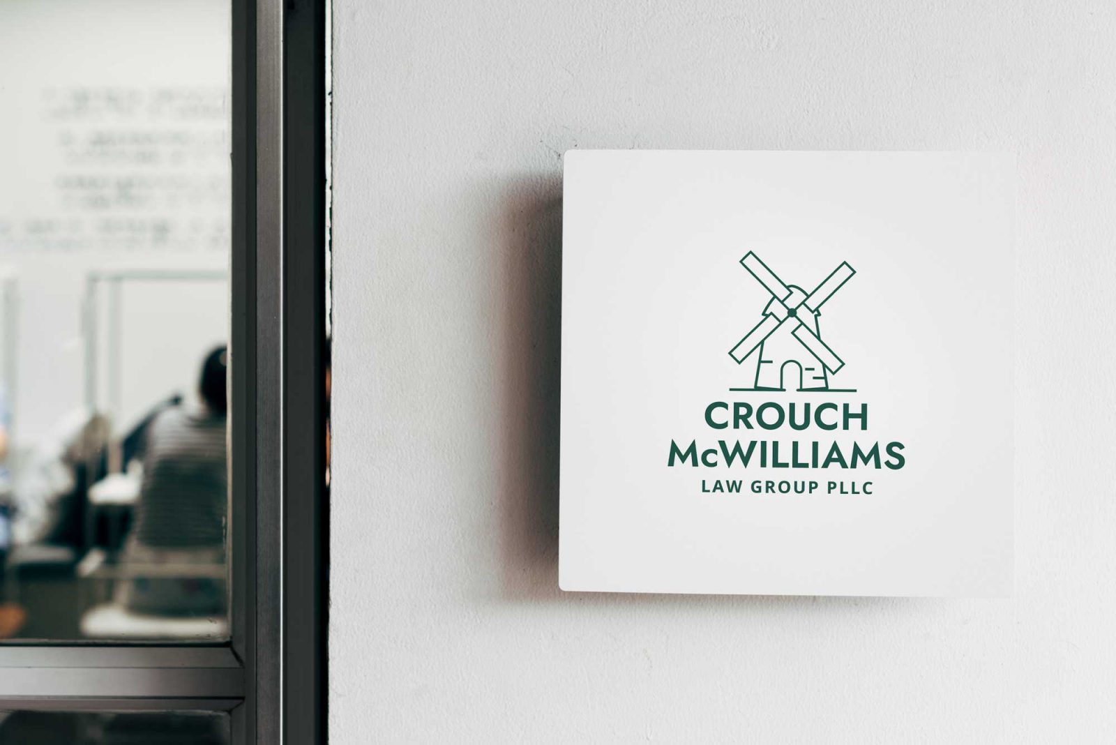 Crouch McWilliams logo design on small office signage
