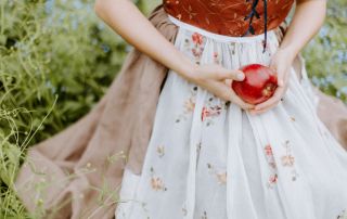 Image of a fairy tale woman holding an apple illustrating brand storytelling.